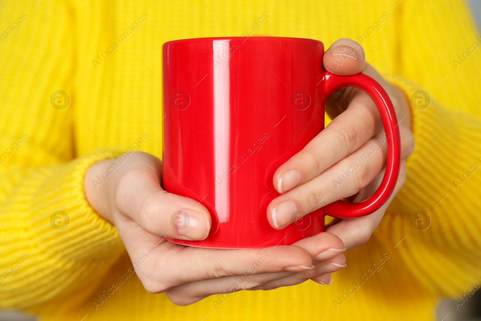 Photo of Woman with red ceramic cup, closeup. Mockup for design