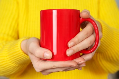 Photo of Woman with red ceramic cup, closeup. Mockup for design