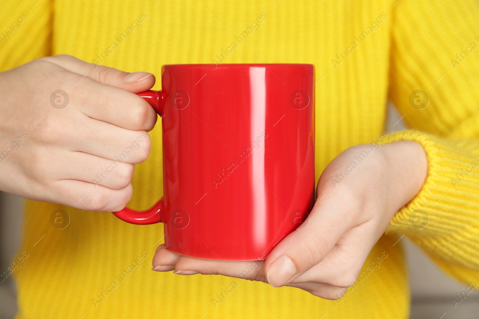 Photo of Woman with red ceramic cup, closeup. Mockup for design