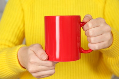 Photo of Woman with red ceramic cup, closeup. Mockup for design