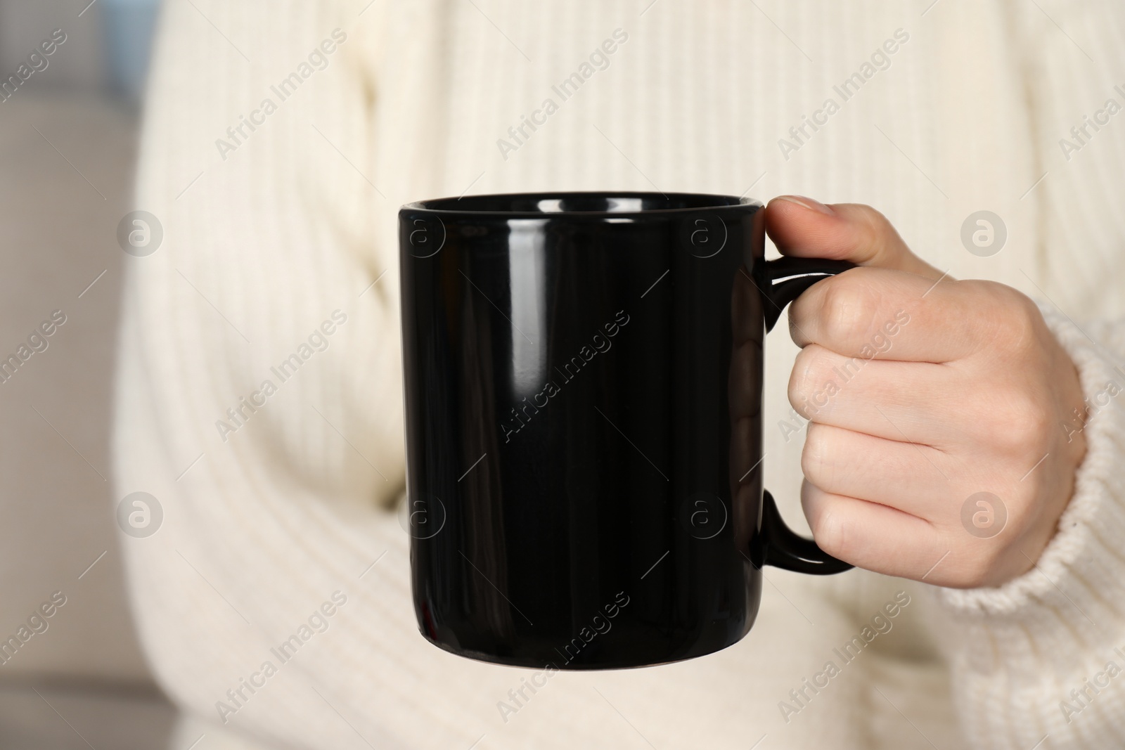 Photo of Woman with black ceramic cup, closeup. Mockup for design