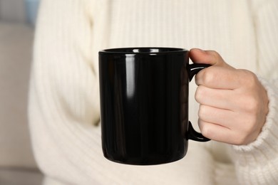 Photo of Woman with black ceramic cup, closeup. Mockup for design