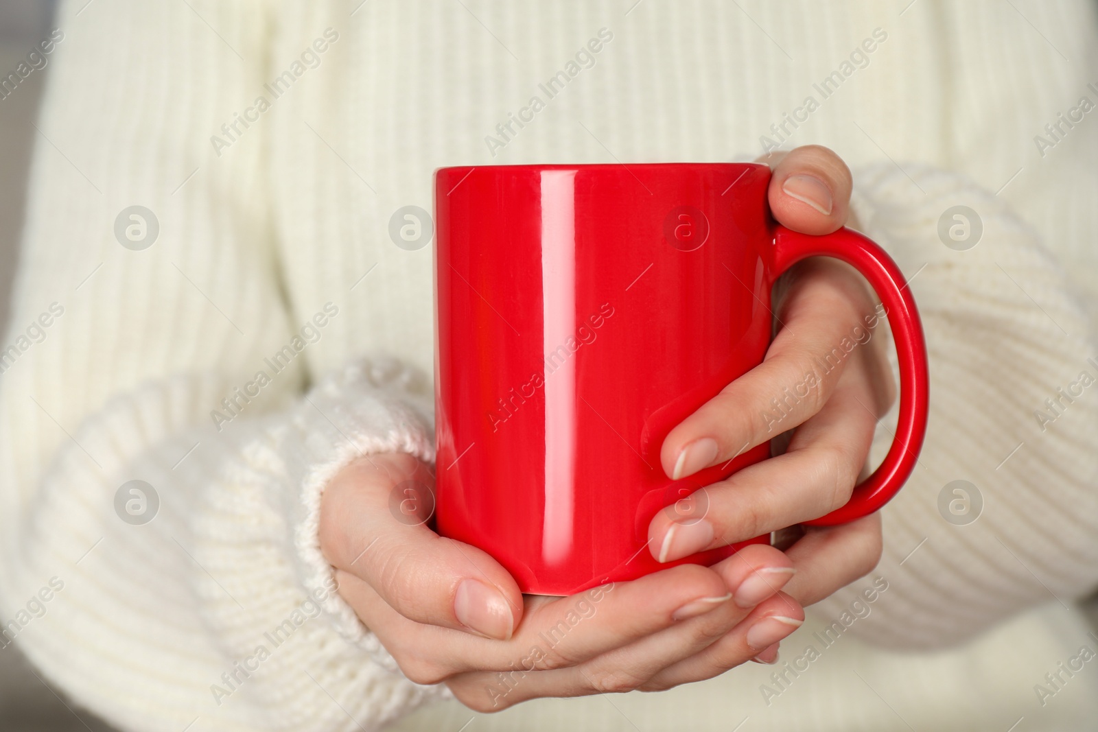 Photo of Woman with red ceramic cup, closeup. Mockup for design