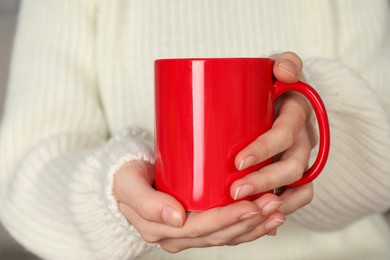 Photo of Woman with red ceramic cup, closeup. Mockup for design