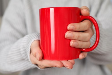 Photo of Woman with red ceramic cup, closeup. Mockup for design