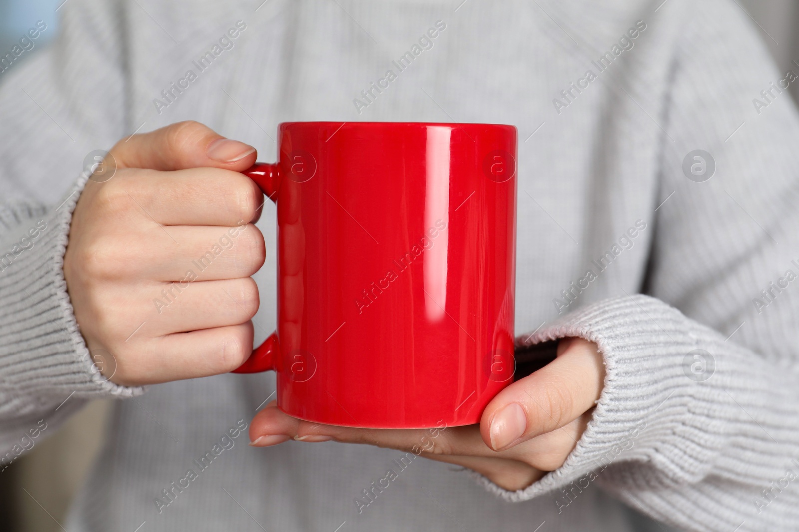 Photo of Woman with red ceramic cup, closeup. Mockup for design