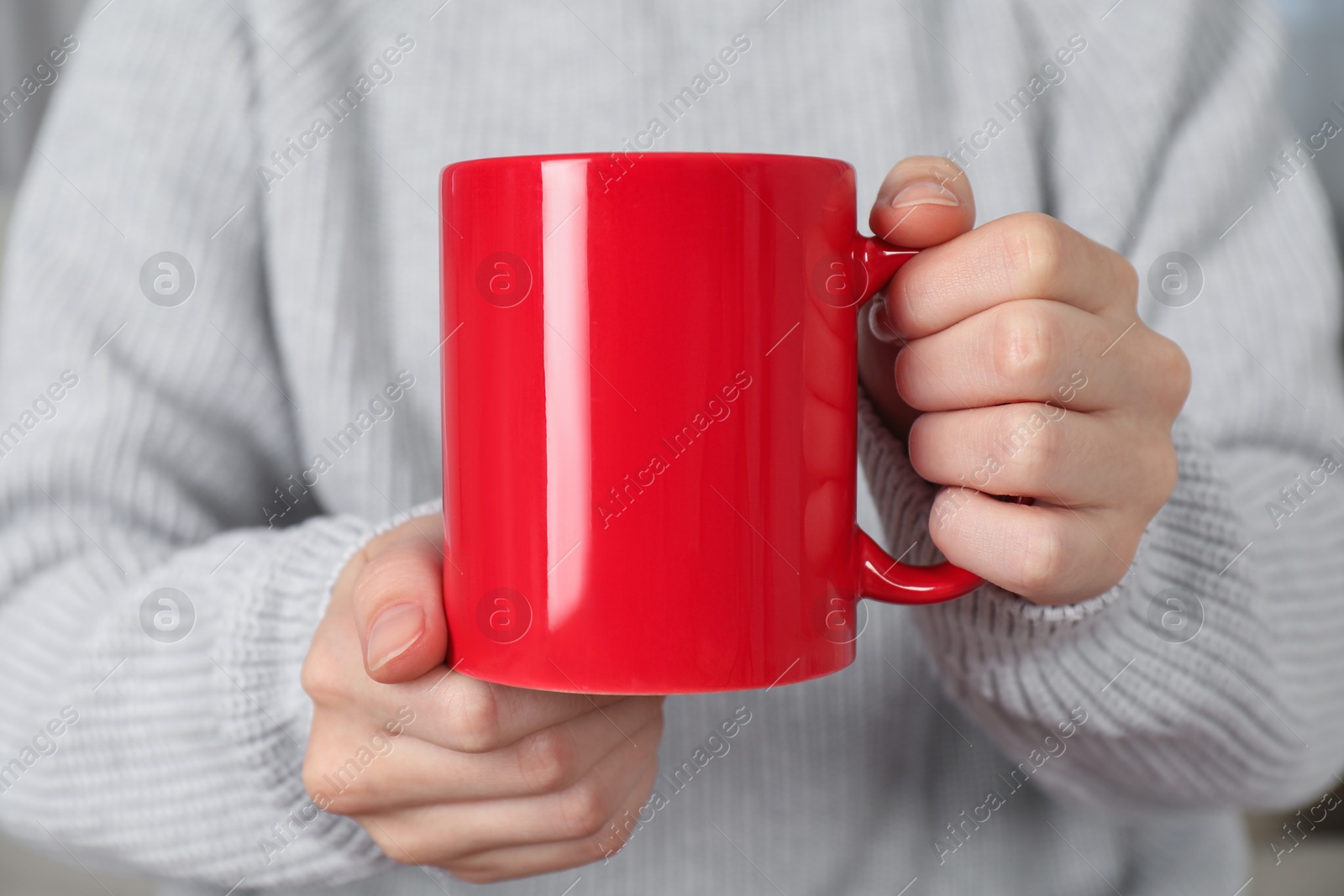 Photo of Woman with red ceramic cup, closeup. Mockup for design