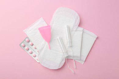 Photo of Flat lay composition with menstrual products on pink background