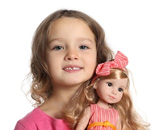 Photo of Cute little girl holding doll on white background