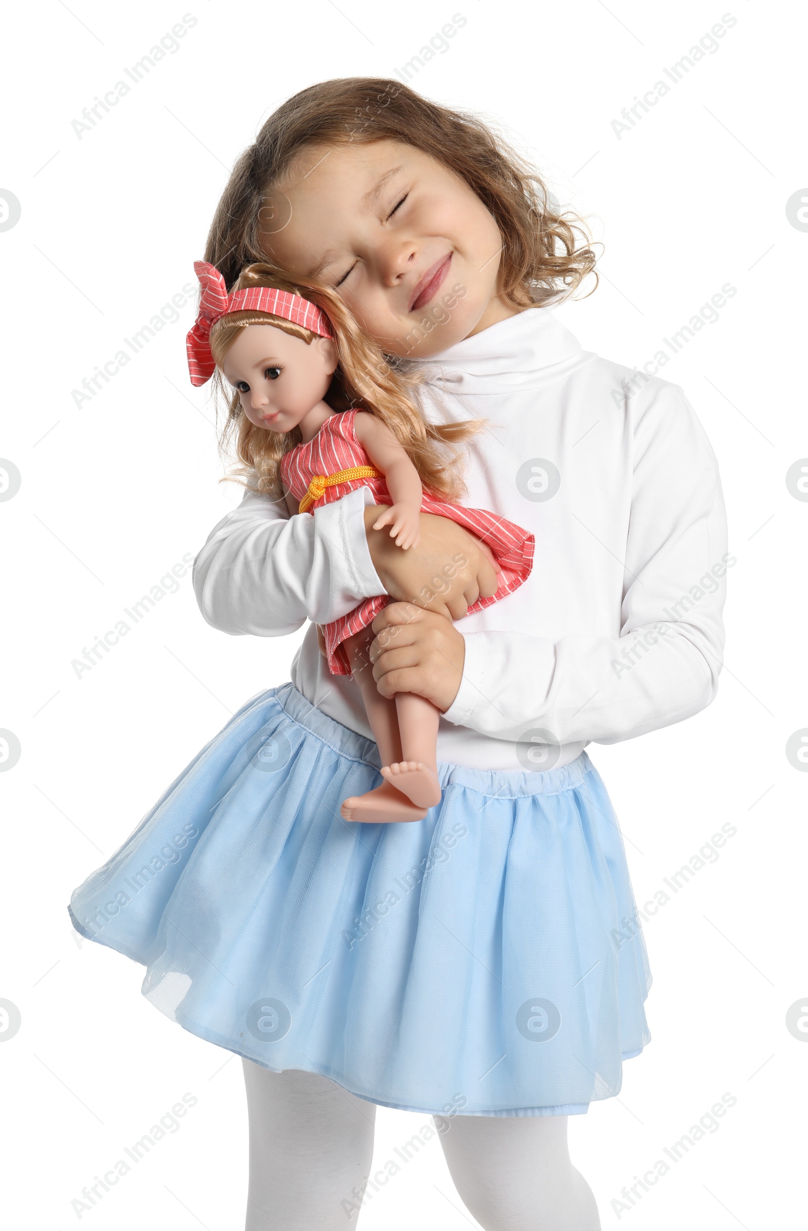 Photo of Cute little girl embracing her doll on white background