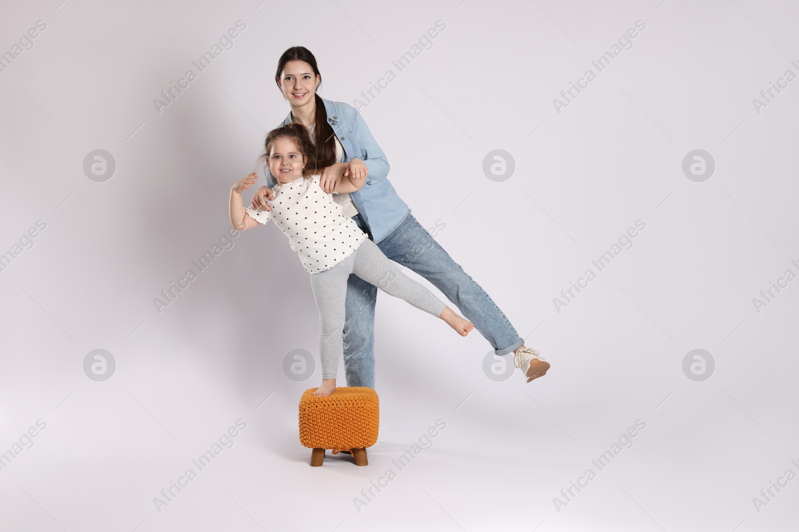 Photo of Full length portrait of cute sisters on white background