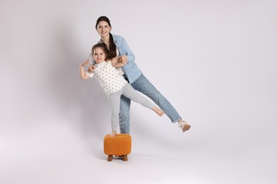 Photo of Full length portrait of cute sisters on white background