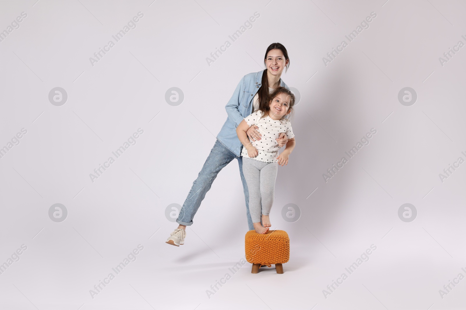 Photo of Full length portrait of cute sisters on white background