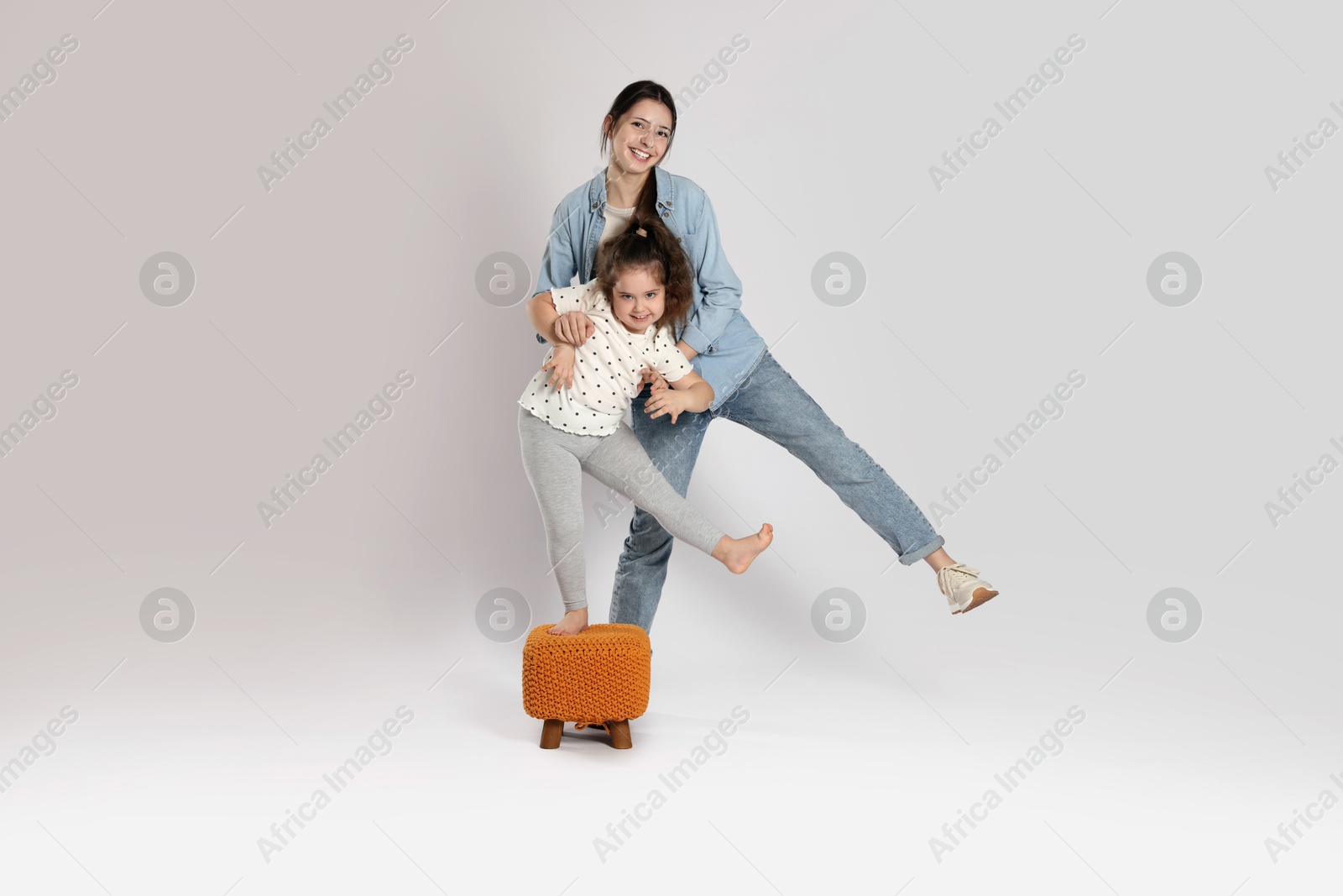 Photo of Full length portrait of cute sisters on white background