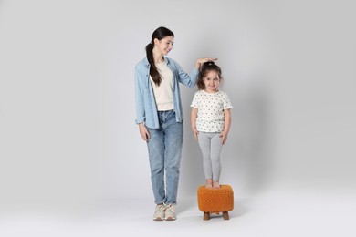 Photo of Full length portrait of cute sisters on white background