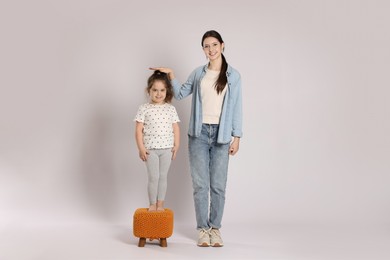 Photo of Full length portrait of cute sisters on white background