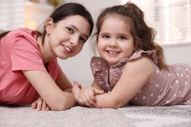 Photo of Portrait of cute little girl and her sister indoors