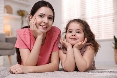 Photo of Portrait of cute little girl and her sister indoors