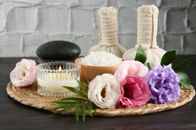 Photo of Spa composition with massage bags on wooden table