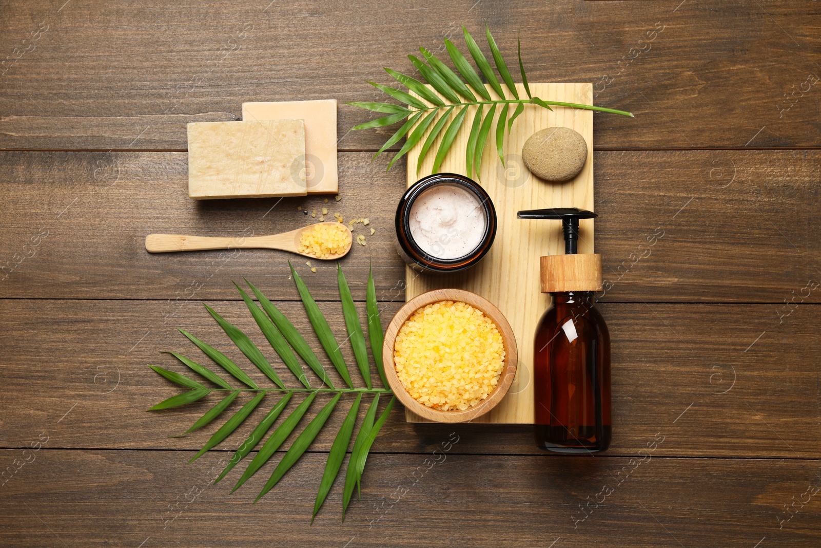 Photo of Spa composition with different cosmetic products on wooden table, flat lay