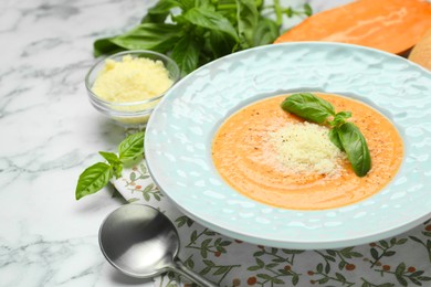 Photo of Delicious sweet potato soup served on white marble table, closeup