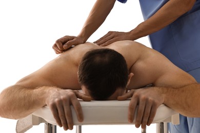 Photo of Professional physiotherapist doing back massage for his client indoors, closeup