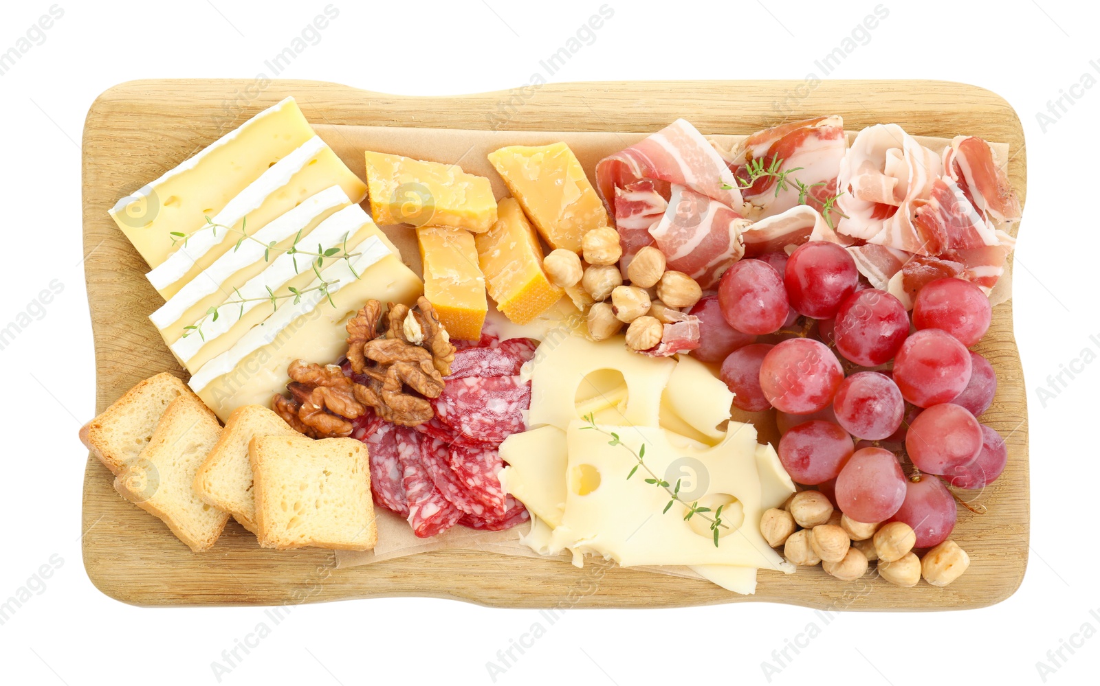 Photo of Different types of cut cheese and other snacks isolated on white, top view