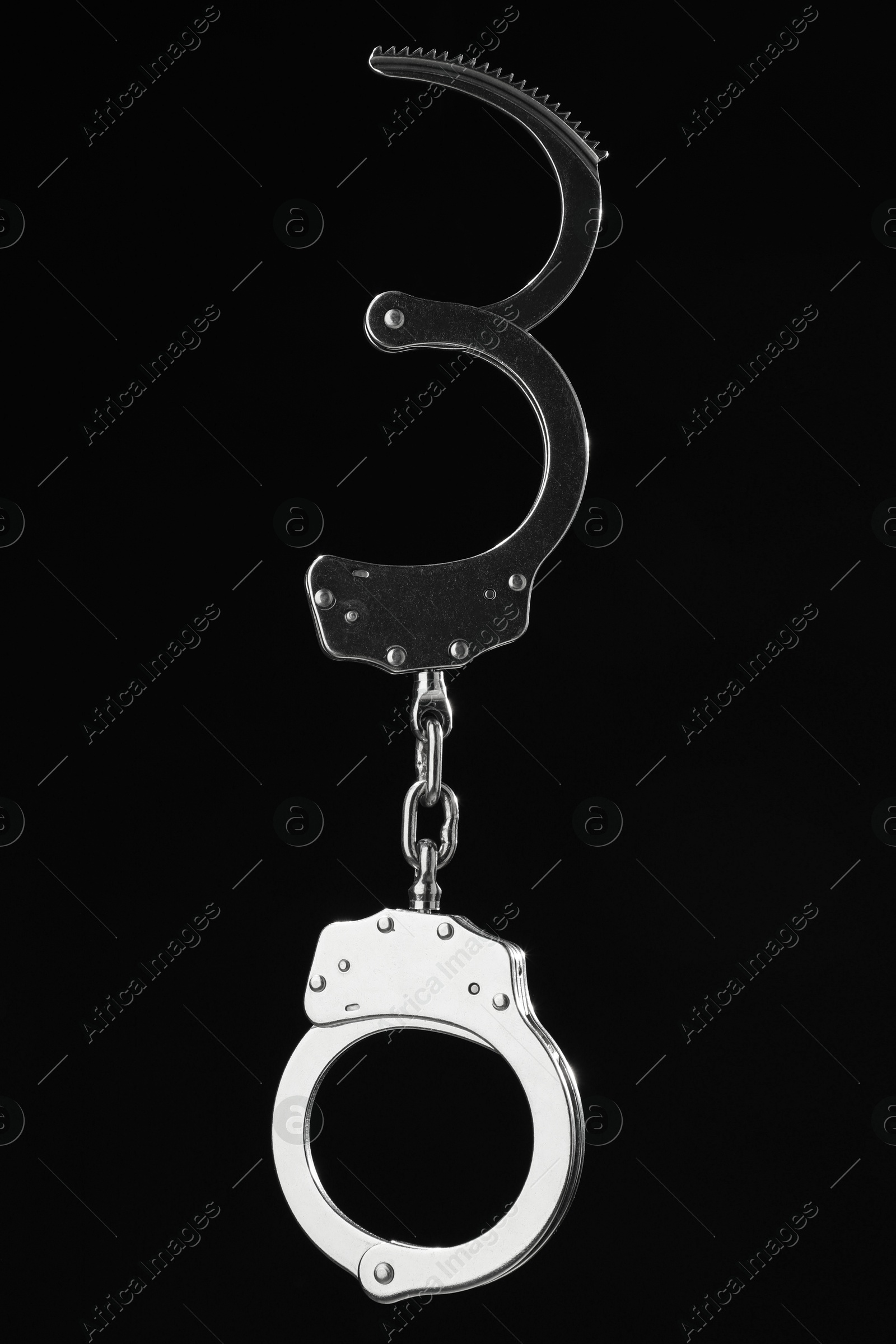 Photo of Metal chain handcuffs on black background, closeup