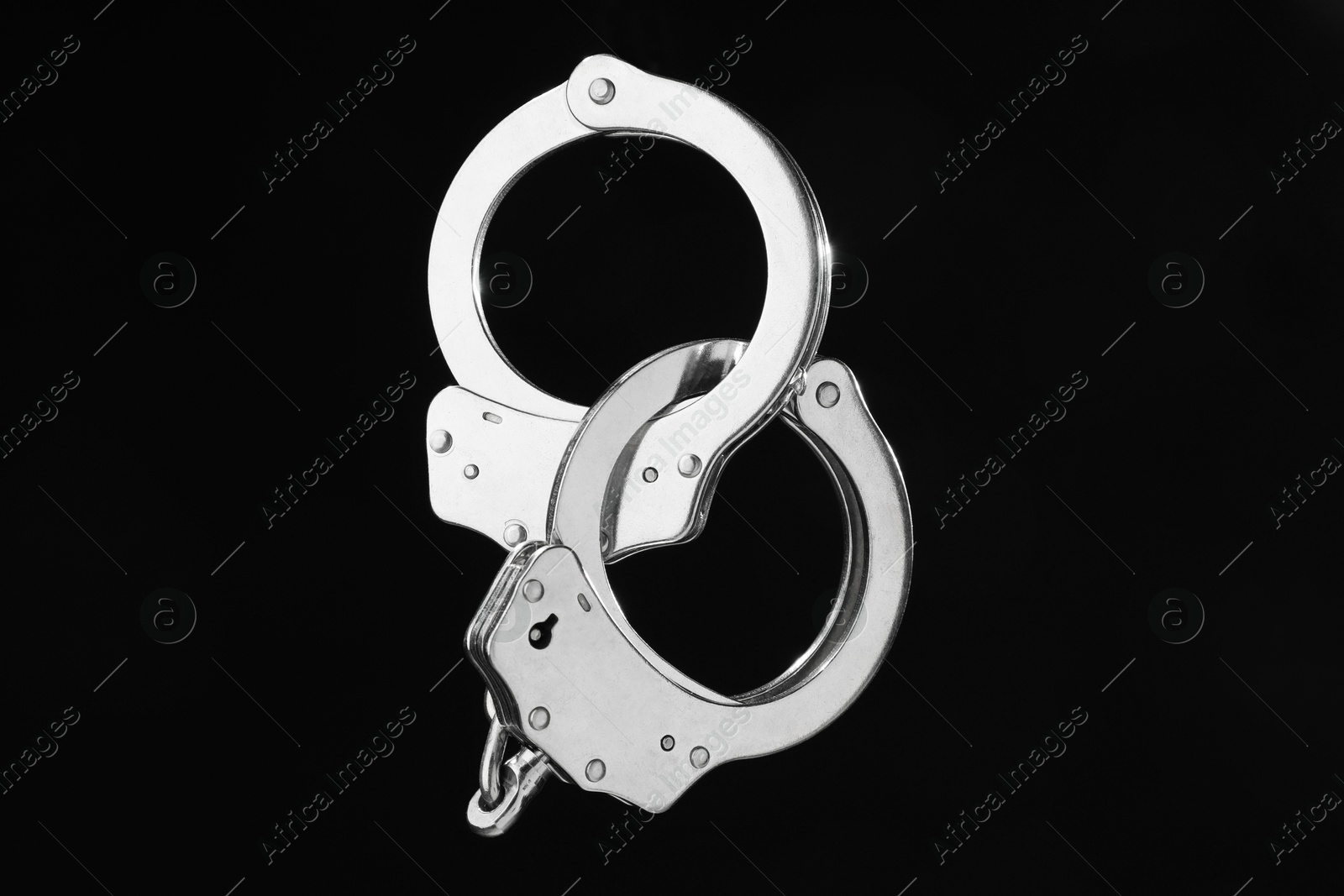 Photo of Metal chain handcuffs on black background, closeup