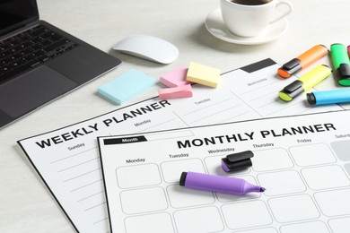 Photo of Timetable. Different planners, stationery, laptop and coffee on white table, closeup