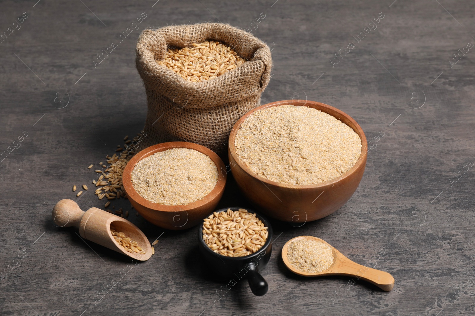 Photo of Oat bran and grains on grey table