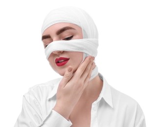 Woman with nose wrapped in medical bandage after plastic surgery operation on white background