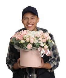 Smiling delivery man holding gift box with beautiful floral composition on white background