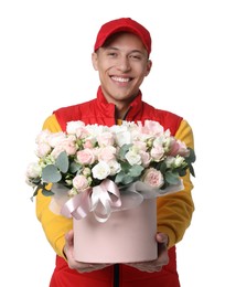 Smiling delivery man holding gift box with beautiful floral composition on white background