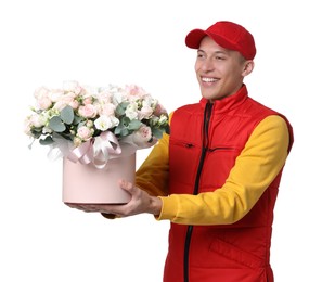 Photo of Smiling delivery man holding gift box with beautiful floral composition on white background