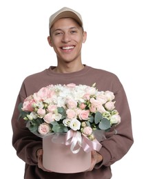 Photo of Smiling delivery man holding gift box with beautiful floral composition on white background