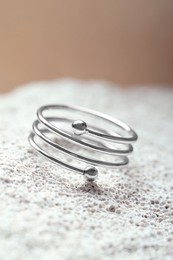 Photo of Beautiful silver ring on stone surface, closeup