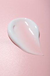 Photo of Cream sample on pink background, closeup. Skincare product