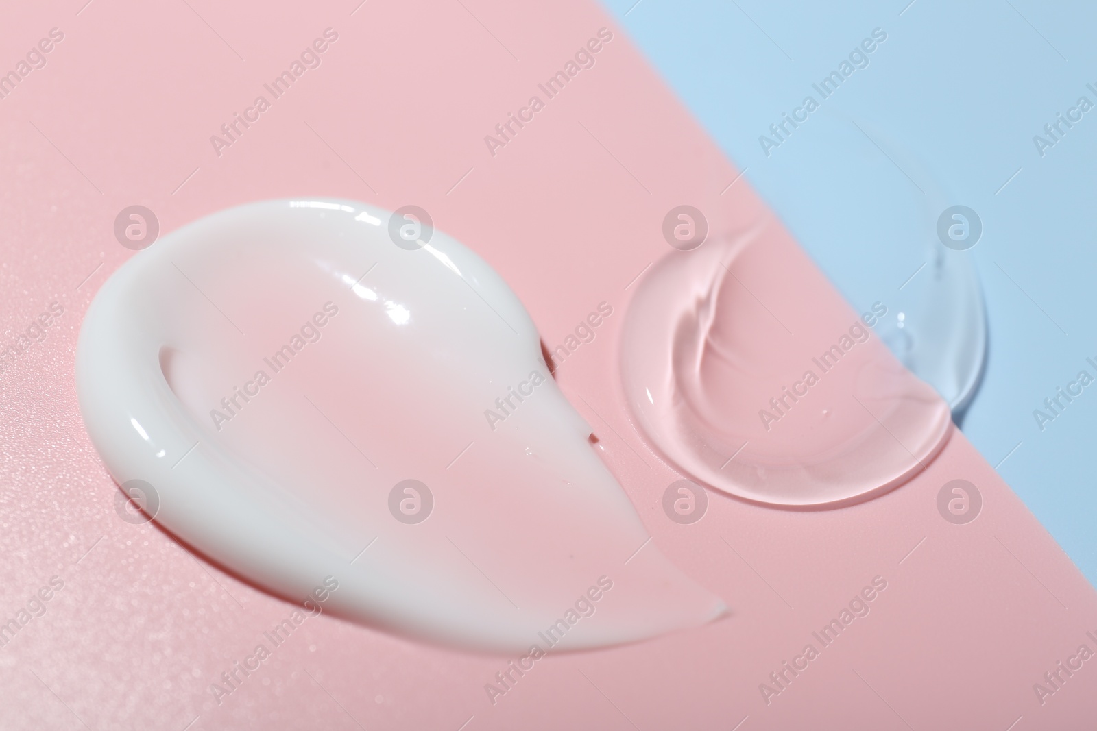 Photo of Cream and gel samples on color background, closeup