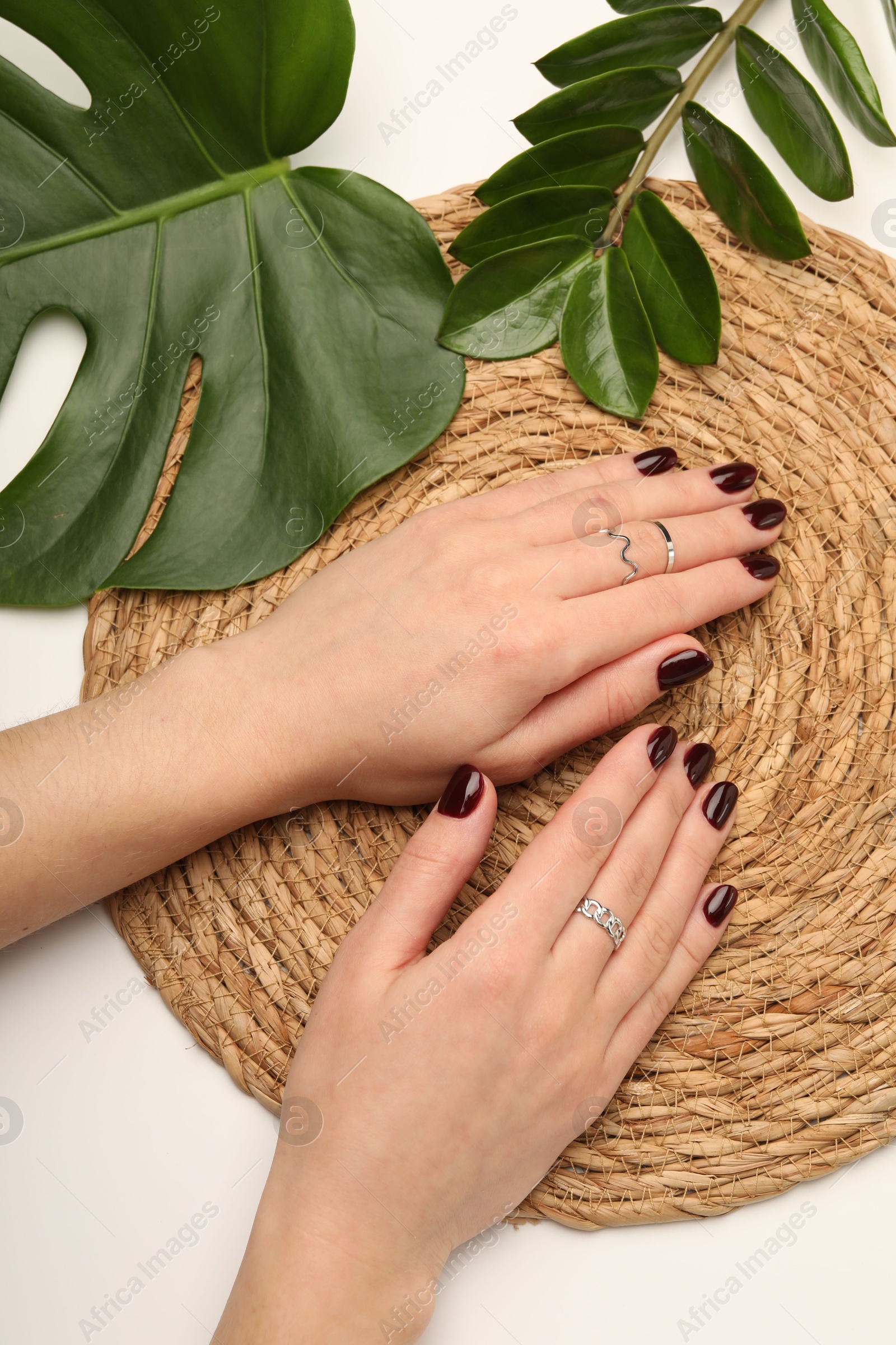 Photo of Woman wearing beautiful rings at white table, top view