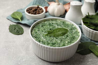 Photo of Delicious spinach sauce served on grey table, closeup