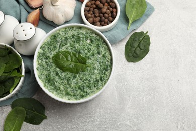 Photo of Delicious spinach sauce served on grey table, flat lay. Space for text