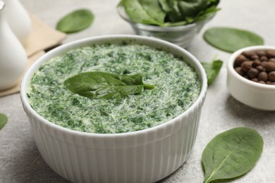 Photo of Delicious spinach sauce served on grey table, closeup