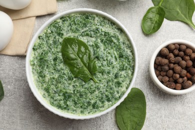 Photo of Delicious spinach sauce served on grey table, flat lay