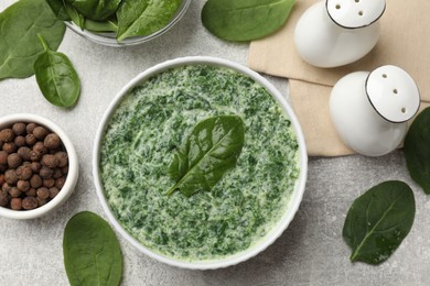 Photo of Delicious spinach sauce served on grey table, flat lay