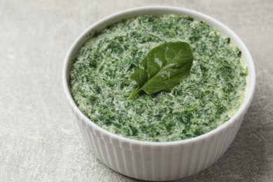 Delicious spinach sauce on grey table, closeup