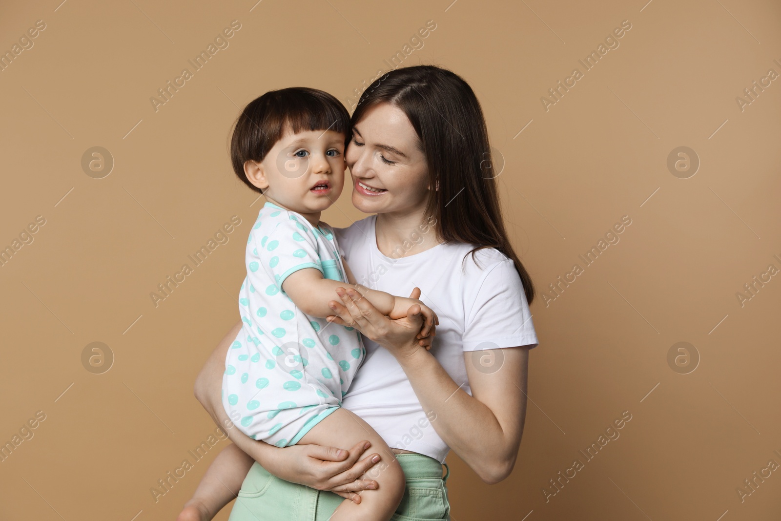 Photo of Family portrait of happy mother with her little son on beige background