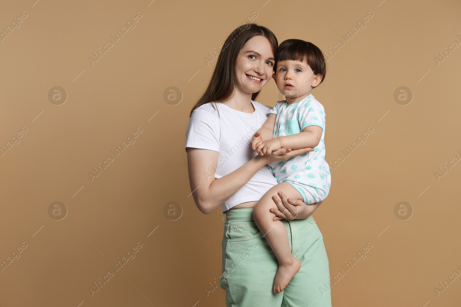 Photo of Family portrait of happy mother with her little son on beige background. Space for text