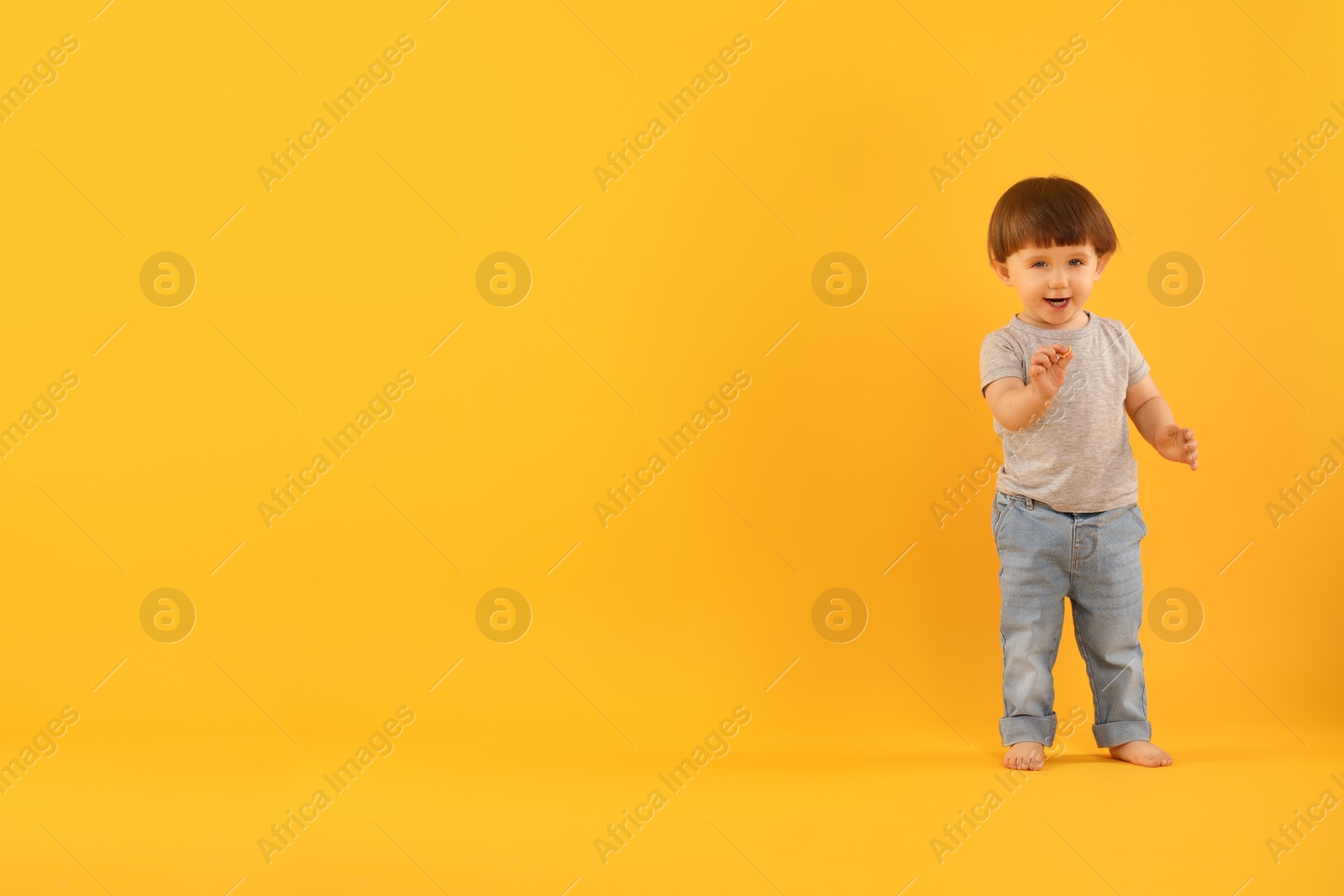 Photo of Cute little boy on yellow background. Space for text