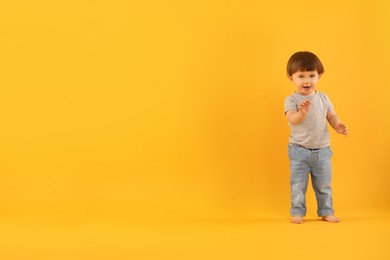 Photo of Cute little boy on yellow background. Space for text